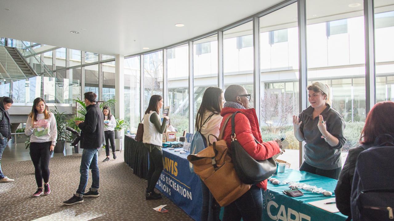 Mental Health Conference attendees mingling at Resource Fair booths.