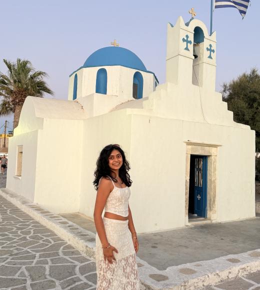 Portrait of Aashi Shah in a white top and skirt in Greece