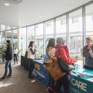 Mental Health Conference attendees mingling at Resource Fair booths.