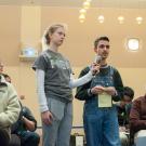 Audience member speaking into a microphone at the town hall.