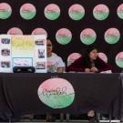 Mental Health Initiative team members sitting at our promotion table during Mental Health Awareness Month.